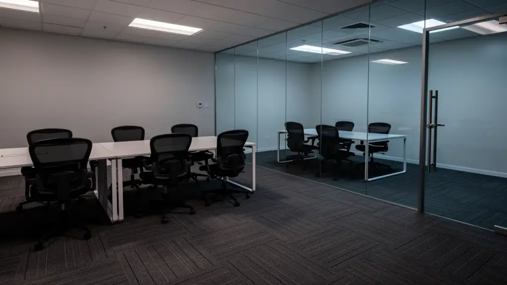 Wiped desks, tucked-in chairs, vacuumed carpet tiles and a glass conference wall without fingerprints.